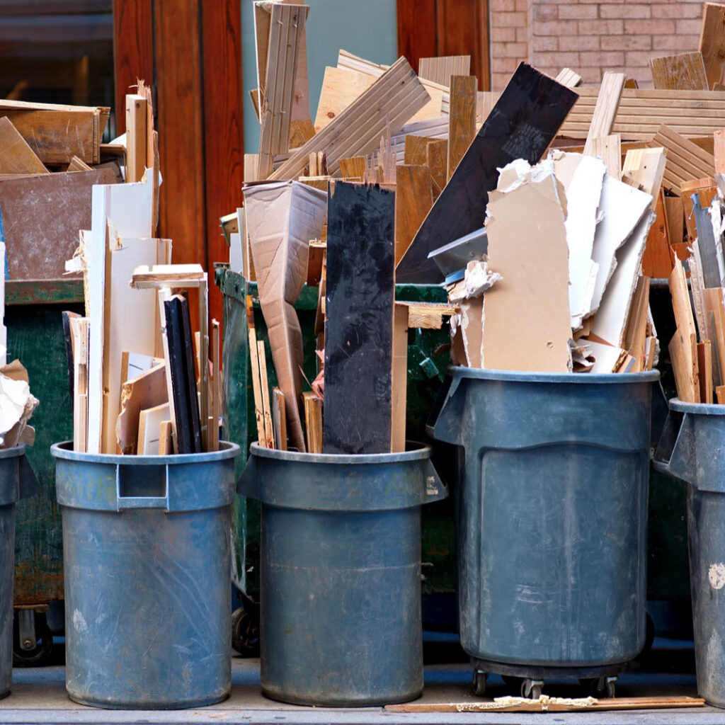 Pile of debris and junk in trash bins in need for Gents Junk