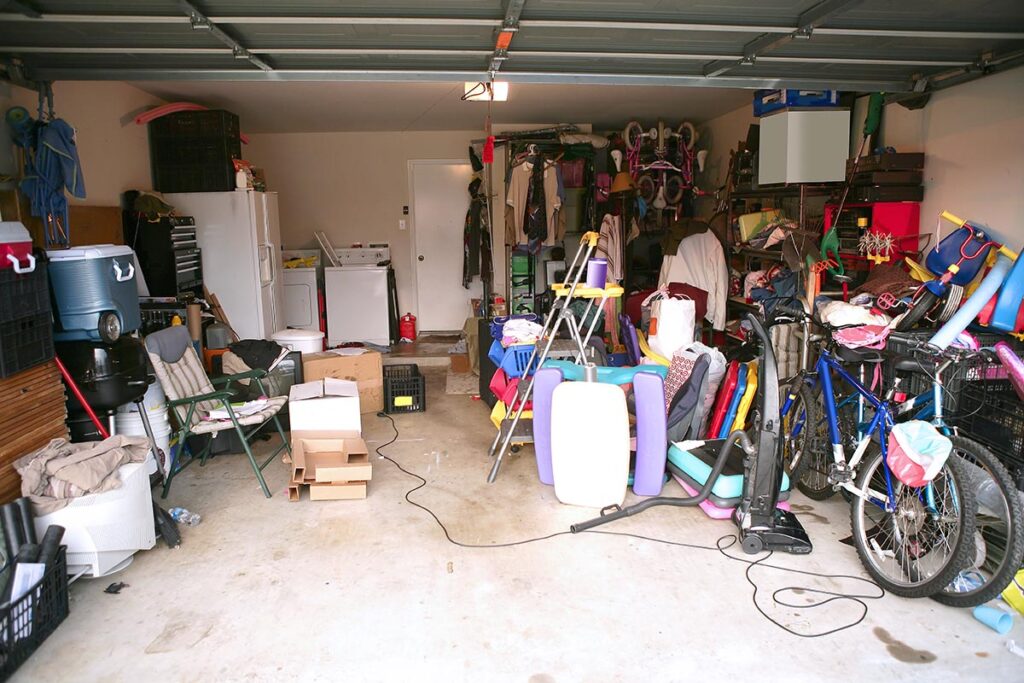 A garage filled with junk in need of clean out and junk removal services by Gent's Junk Removal